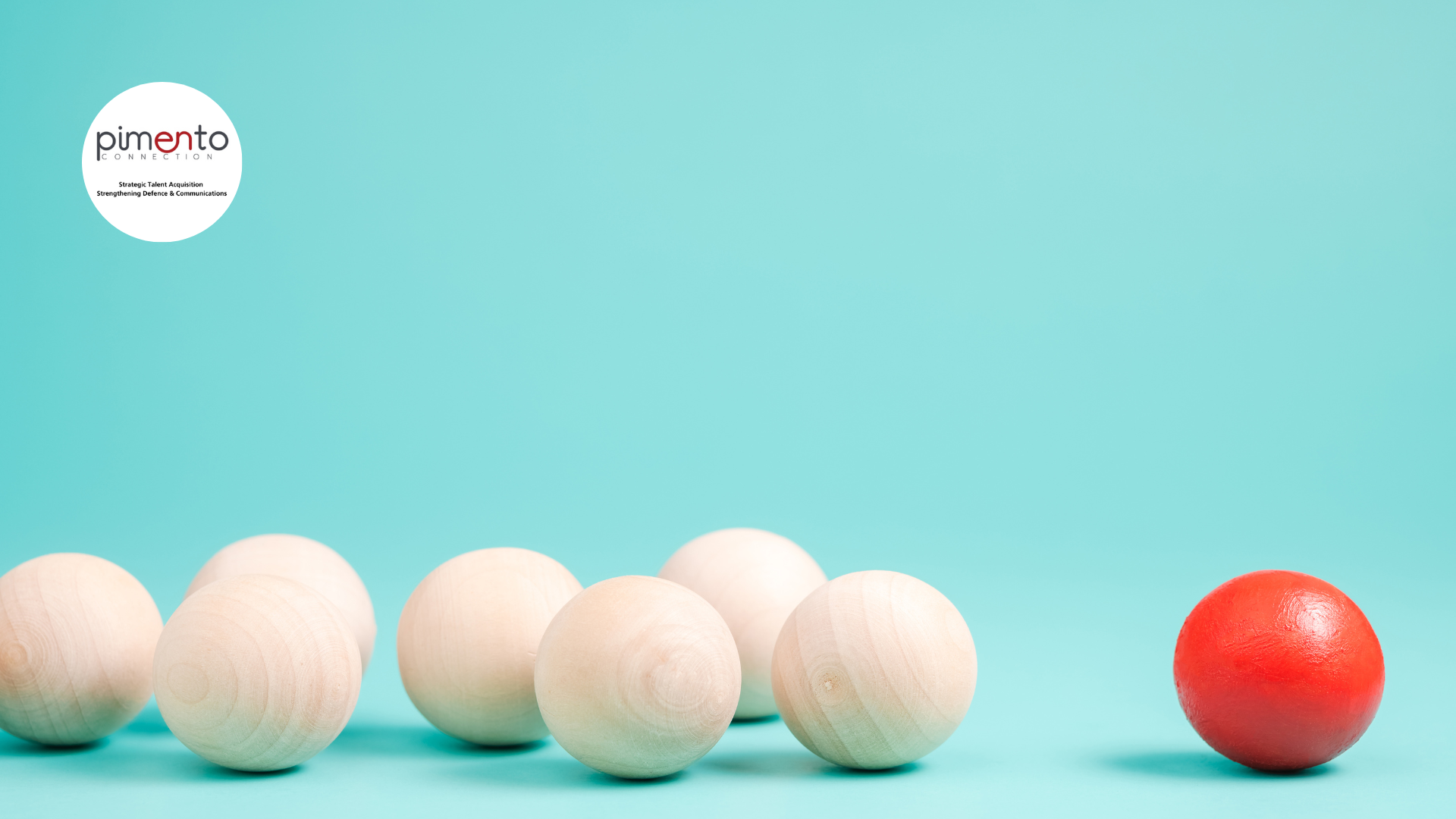 turquoise background, 7 wooden balls on the left, one red wooden ball on the right