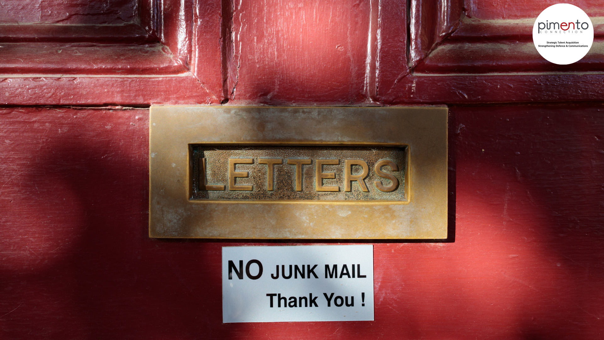 Red front door, brass letter box with 'no junk mail thank you!' sign